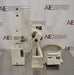 Front eye-level view of Buchi R-100 rotary evaporator system showing vertical glass condenser, receiving flask, digital controller module, and heating bath