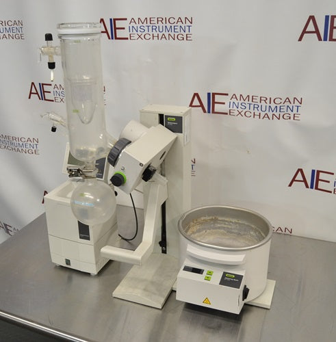 Right angled perspective view of Buchi R-100 rotary evaporator system showing heating bath, vertical condenser, receiving flask, and support stand base