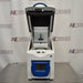 Front perspective view of Cole-Parmer Geno Grinder 2010 tissue homogenizer with open lid showing internal grinding clamp assembly and digital control panel