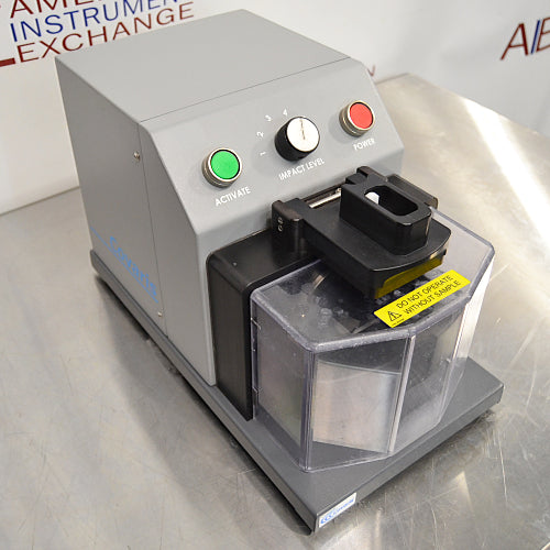 Right three-quarter angle product view of a Covaris cryoPREP CP02 dry pulverizer, featuring its grey housing, clear protective safety shield, impact level dial, and top control buttons