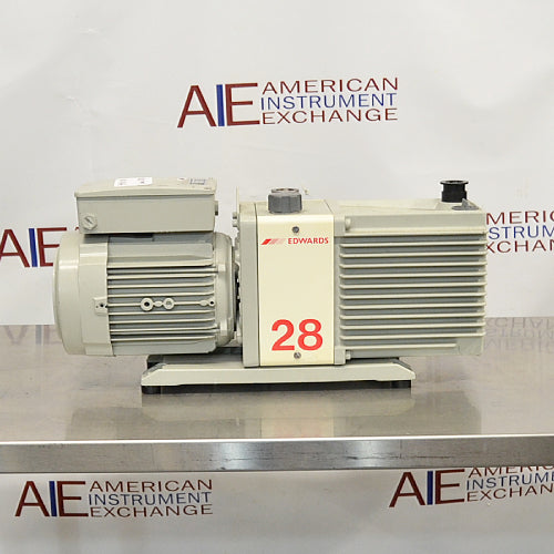 Rear product view of an Edwards E2M28 rotary vane vacuum pump, featuring its finned motor housing, prominent red model number 28 label, and vacuum port on a stainless steel surface