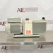 Rear product view of an Edwards E2M28 rotary vane vacuum pump, featuring its finned motor housing, prominent red model number 28 label, and vacuum port on a stainless steel surface