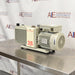 Right angle product view of an Edwards E2M28 rotary vane vacuum pump, featuring its gray finned housing, prominent red model number 28 label, and the rear electric motor fan housing on a stainless steel surface