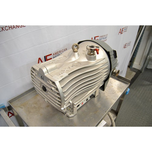Three-quarter high-angle front view of an Edwards nXDS6i dry scroll vacuum pump on a metal utility cart, displaying the front grill marked with 6i, top inlet port, and cooling fins