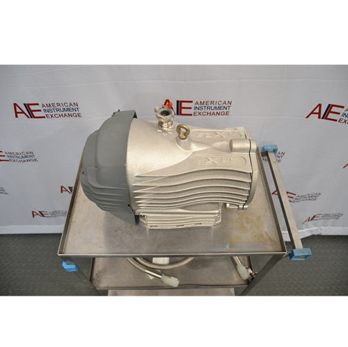 High three-quarter view from above showing an Edwards nXDS6i dry scroll vacuum pump on a stainless steel utility cart, highlighting its top inlet port, lifting eyelet, and finned body casing