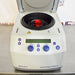 Front eye-level view of an Eppendorf 5425R refrigerated microcentrifuge with its top lid open, showing the internal rotor with a red locking lid and the front digital control panel