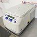 Right angled perspective view of an Eppendorf 5425R refrigerated microcentrifuge on a stainless steel surface, highlighting its light grey housing, closed lid, side ventilation vents, and front control panel with dual blue knobs