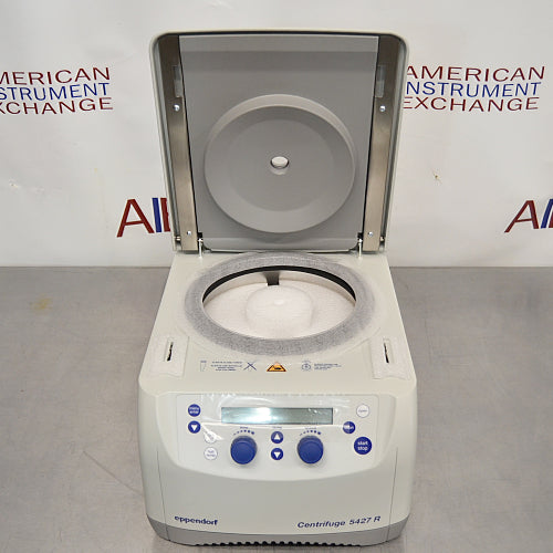 Front view of an Eppendorf 5427R refrigerated microcentrifuge with its lid lifted open, revealing the internal rotor chamber, gasket seal, and the digital control console on the lower front housing