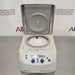 Front view of an Eppendorf 5427R refrigerated microcentrifuge with its lid lifted open, revealing the internal rotor chamber, gasket seal, and the digital control console on the lower front housing