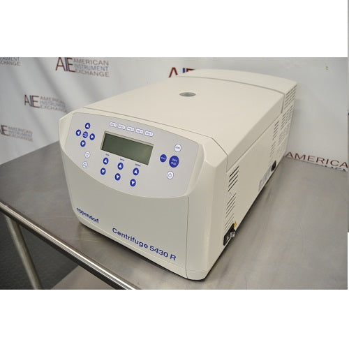 Left angled perspective view of Eppendorf 5430 R refrigerated benchtop centrifuge with closed lid on stainless steel table featuring keypad control panel