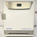 Front product view of an Eppendorf New Brunswick S41i CO2 incubator with integrated shaker, featuring a white-and-gray exterior, top digital control display panel, side latch handle, and brand logos on a workbench