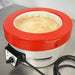 Left three-quarter angle product view of a Fisatom laboratory heating mantle, showing its red top rim, white body, integrated control box with power dial, specifications label, and power cord on a lab bench