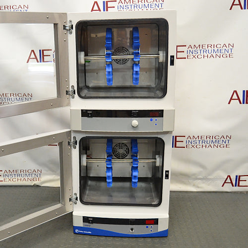 Front product view of a Fisher dual chamber hybridization incubator with both glass doors swung open, highlighting the stacked internal chambers equipped with blue bottle rotisserie carousels and digital control panels