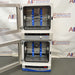 Front product view of a Fisher dual chamber hybridization incubator with both glass doors swung open, highlighting the stacked internal chambers equipped with blue bottle rotisserie carousels and digital control panels