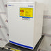 Right angled perspective view of a Fisher Scientific Isotemp general purpose undercounter freezer on a cart, featuring a white cabinet body, solid door with branding, and a yellow warning label
