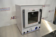 Angled perspective view of a Fisher vacuum oven model 281A showing its right side panel, latch handle, and front control setup on a stainless steel surface