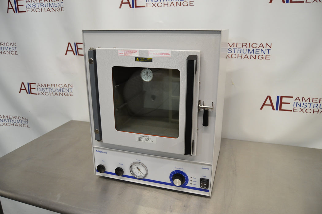 Front eye-level view of a Fisher vacuum oven model 281A resting on a stainless steel surface, featuring a heavy-duty insulated glass door with a latch handle and a lower control panel with pressure gauge and dials