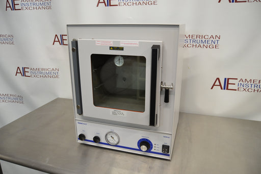 Front eye-level view of a Fisher vacuum oven model 281A resting on a stainless steel surface, featuring a heavy-duty insulated glass door with a latch handle and a lower control panel with pressure gauge and dials