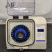 Fisherbrand Bead Mill 24 homogenizer ka open front view, jisme upar ki taraf khula hua protective lid, blue 24-tube sample carriage rotor, aur digital control panel saaf dikhai de rahe hain.   