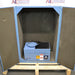 Front product view of a Gilson sieve shaker inside a sound enclosure with open acoustic foam-lined doors, showcasing the blue sieve shaker unit resting on a wooden pallet base