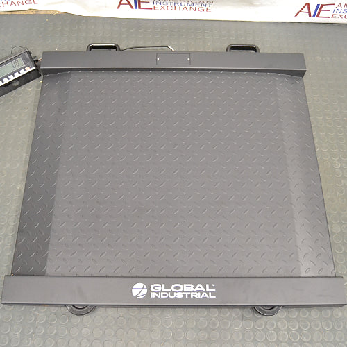Top-down product view of a Global Industrial 318506 drum scale with an LCD indicator, showcasing the heavy-duty diamond plate platform, integrated ramps, and branding on the front edge
