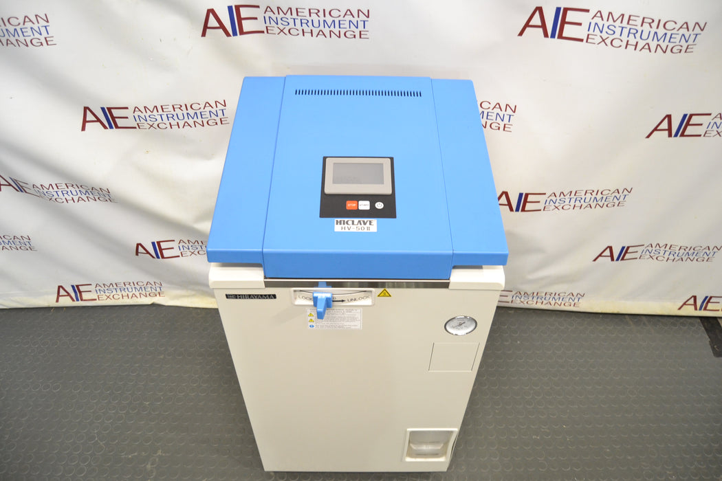 Top-down view of a Hirayama HV-50II vertical autoclave demo unit with its lid closed, highlighting the blue top panel featuring the digital display interface, front control lever, pressure gauge, and white cabinet body
