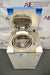 Top-down angled view of a Hirayama HV-50II vertical autoclave demo unit with the lid fully raised, displaying the open stainless steel chamber interior, inner wire basket, control interface, and pressure gauge