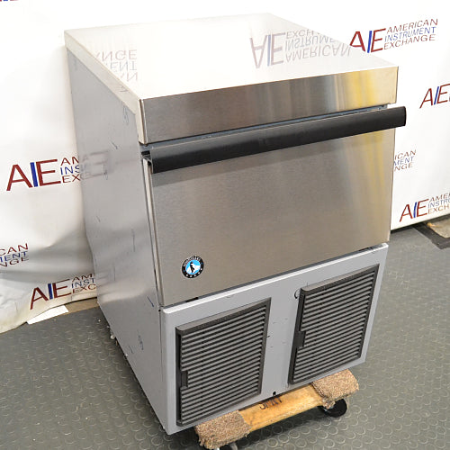 Left three-quarter angle product view of a Hoshizaki F330 BAJ flaker ice maker, highlighting the stainless steel top, front bin door with black handle, and side panels