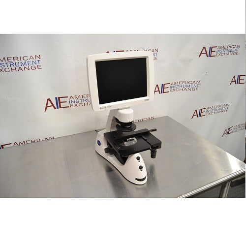Angled perspective view of an Invitrogen EVOS XL Core cell imager resting on a stainless steel surface highlighting its side profile, stage controls, and integrated digital monitor