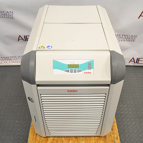 Front product view of a Julabo FL1701 recirculating chiller, featuring its white and gray housing, digital control panel display, and lower slatted ventilation grille on a wooden platform