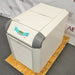 Right three-quarter angle product view of a Julabo FL1701 recirculating chiller, showcasing its white and gray body, angled digital control panel, lower vented grille, and solid side panel resting on a wooden pallet