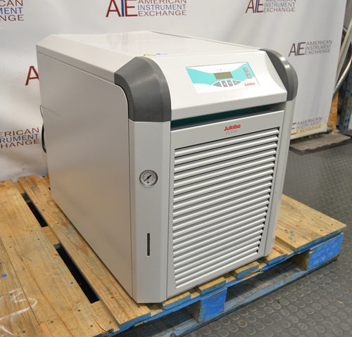 Left angled perspective view of Julabo FL1703 recirculating chiller showing side casing, front louvered vent, pressure gauge, and digital control keypad