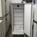 Front view of a K2 Scientific K210SDR high-performance laboratory refrigerator with its door open, showcasing the white interior lining, multiple wire shelves, internal ventilation fan, and magnetic door gasket