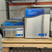 Front product view of a Labconco CentriVap centrifugal vacuum concentrator setup on a wooden pallet, featuring a stainless steel and blue housing, control panel, and paired cold trap unit