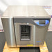 Elevated front product view of a Labconco FlaskScrubber Vantage 422101010 glassware washer, featuring its stainless steel finish, digital control interface, and viewing window on a wooden pallet