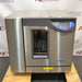 Front product view of a Labconco FlaskScrubber Vantage 422101010 glassware washer, showcasing its stainless steel housing, digital control console, and a central glass door window on a wooden pallet base
