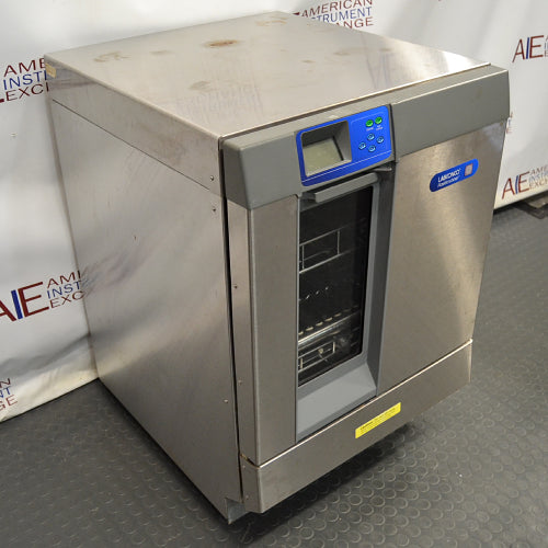 Right angled perspective view of a Labconco Freestanding Glassware Washer (Model 4420430) on a dark textured surface, highlighting its stainless steel side and top panels, front control console, and the glass drop-down door exposing internal wire racks