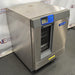 Right angled perspective view of a Labconco Freestanding Glassware Washer (Model 4420430) on a dark textured surface, highlighting its stainless steel side and top panels, front control console, and the glass drop-down door exposing internal wire racks