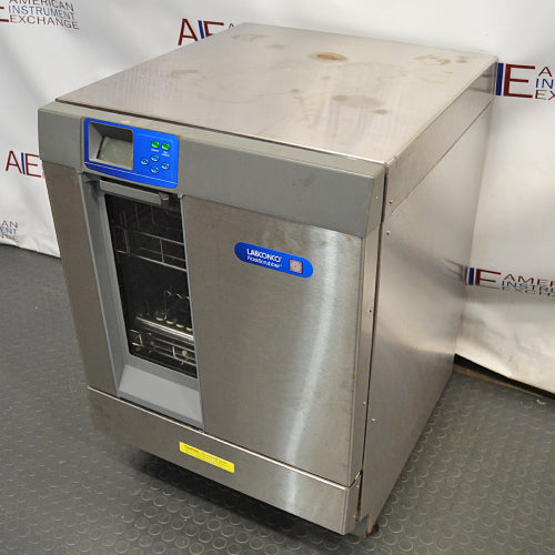 Right-angled perspective view of a Labconco Freestanding Glassware Washer (Model 4420430) on a dark textured surface, highlighting its stainless steel housing, top control panel with blue insert, and vertical viewing window on the door