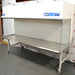 Left angle product view of a Labconco Purifier clean bench, showcasing its stainless steel workspace, clear side panels, mobile caster stand, and top control console
