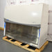 Left angle product view of a Labconco Purifier Logic+ Type A2 biosafety cabinet, featuring its stainless steel interior deck, closed glass sash, and white exterior housing on a wooden pallet