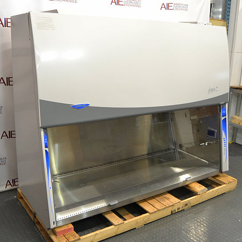 Left angle product view of a Labconco Purifier Logic+ Type A2 biosafety cabinet, featuring a stainless steel interior workspace, glass sash, and exterior housing on a wooden shipping pallet