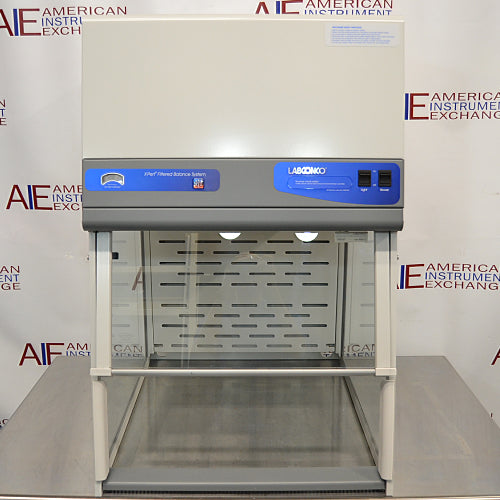 Front product view of a Labconco XPert filtered balance system, showcasing its containment enclosure, upper airflow housing, control panel with switches, integrated lighting, and clear sash on a laboratory counter