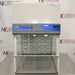 Front product view of a Labconco XPert filtered balance system, showcasing its containment enclosure, upper airflow housing, control panel with switches, integrated lighting, and clear sash on a laboratory counter