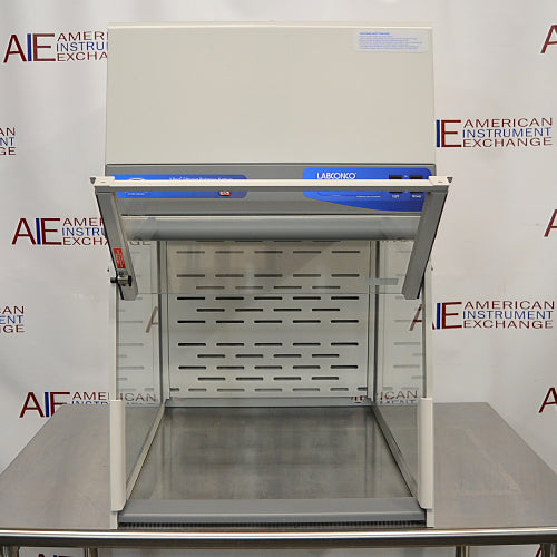 Front product view of a Labconco XPert filtered balance system powder containment hood with its front glass sash fully raised, revealing the interior stainless steel deck and slotted rear baffle