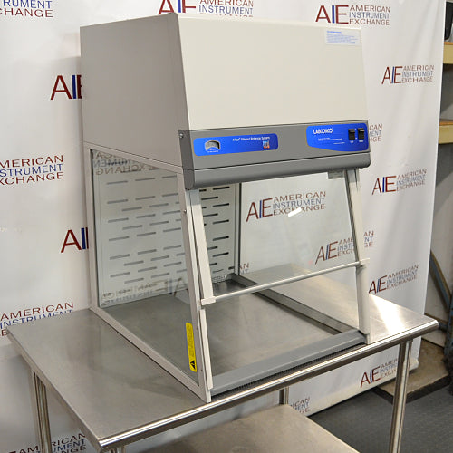Three-quarter angle product view of a Labconco XPert filtered balance system powder containment hood, showcasing its upper airflow module, transparent side and front sashes, and stainless steel work table