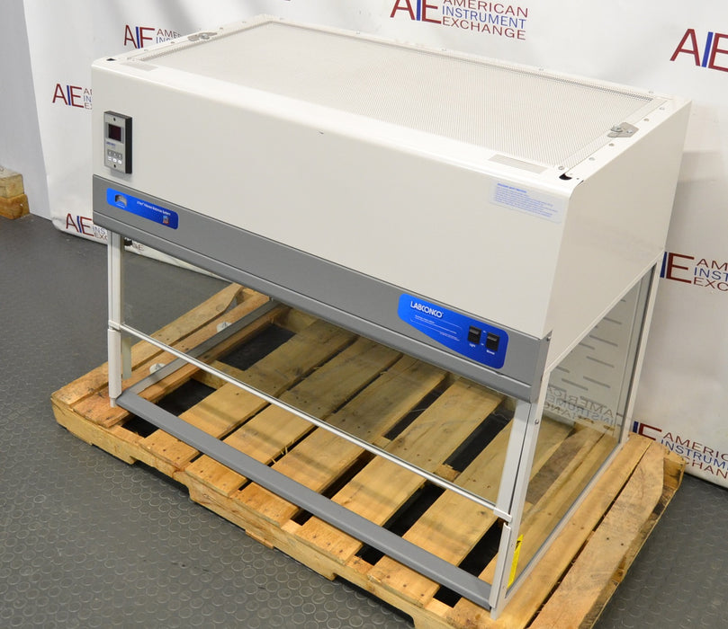 Right angled perspective view of a Labconco XPert Filtered Balance System mounted on a wooden shipping pallet, showing its top filter grill, control panel, and transparent enclosure structure