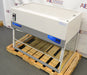 Right angled perspective view of a Labconco XPert Filtered Balance System mounted on a wooden shipping pallet, showing its top filter grill, control panel, and transparent enclosure structure