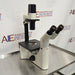 Leica DM IRB inverted research microscope ka right angle view, jisme binocular viewing head, mechanical stage, vertical illumination column, aur focus adjustment knobs saaf dikhai de rahe hain.