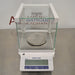 Mettler Toledo ME403E precision balance ka front view, jisme glass draft shield enclosure, stainless steel weighing pan, digital LCD display, aur front control keypad saaf dikhai de rahe hain.   